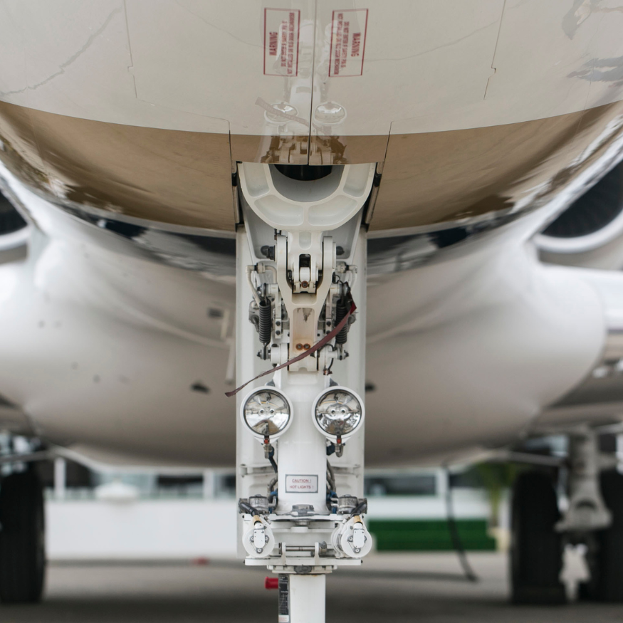 Close-up view of an aircraft nose landing gear assembly.